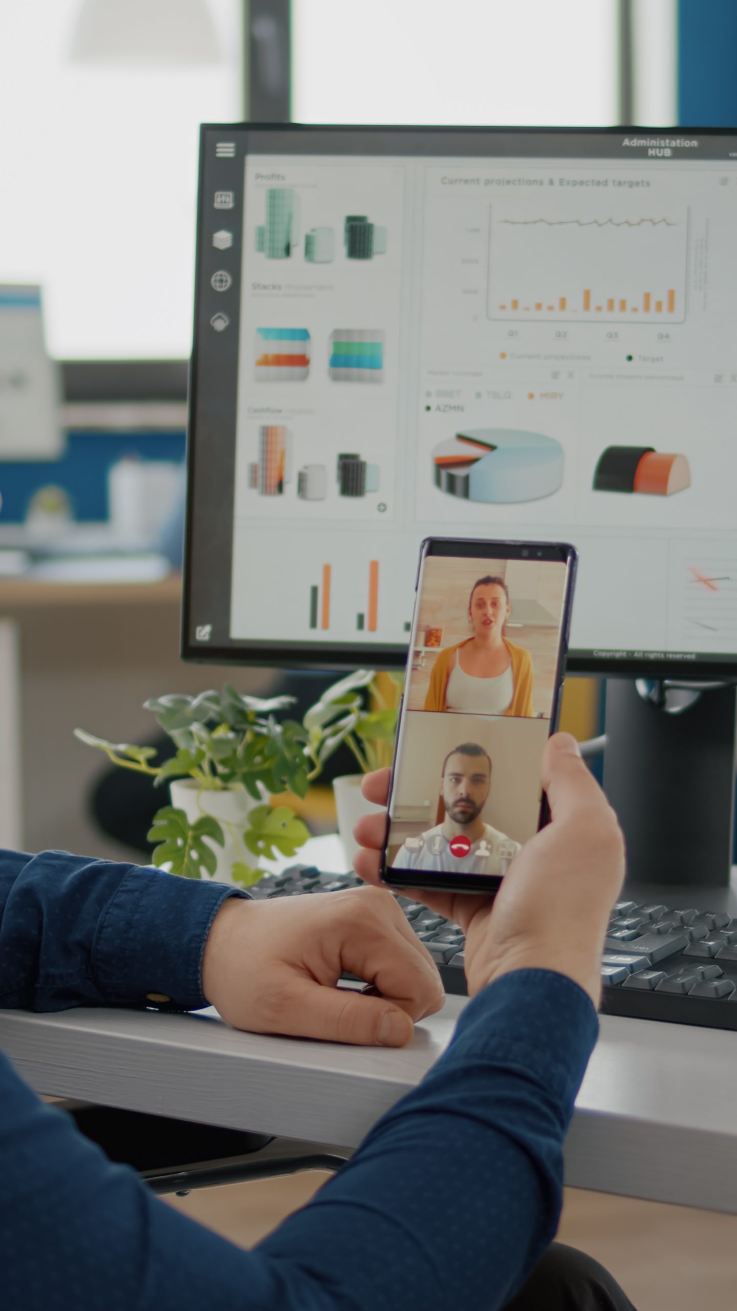 Disabled, invalid businessman in wheelchair discussing with friends on video call holding phone using headphones taking break sitting in business office. Diverse coworkers planning financial project